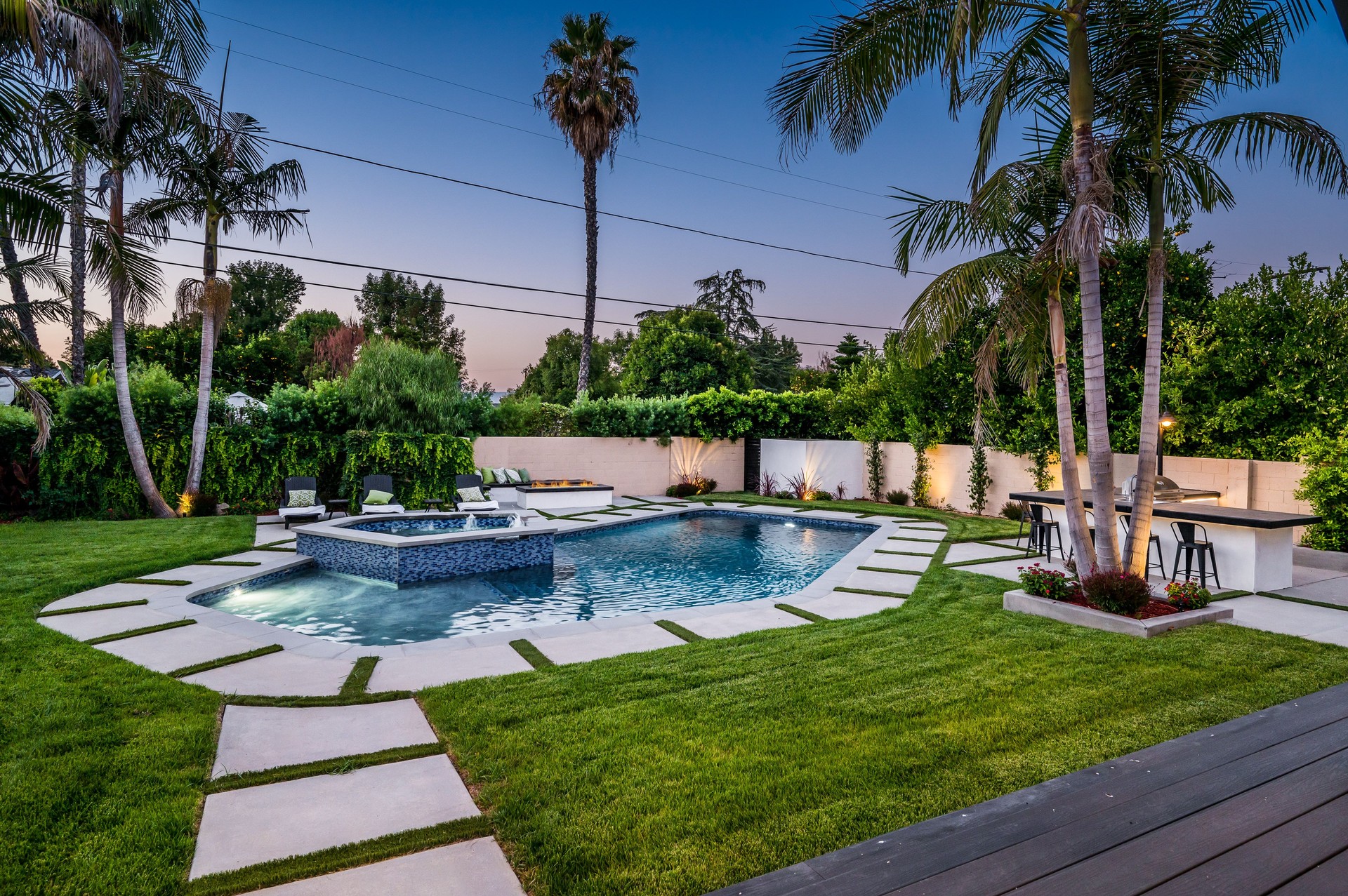 Backyard pool in a verdant garden setting in a modern new construction home in Los Angeles